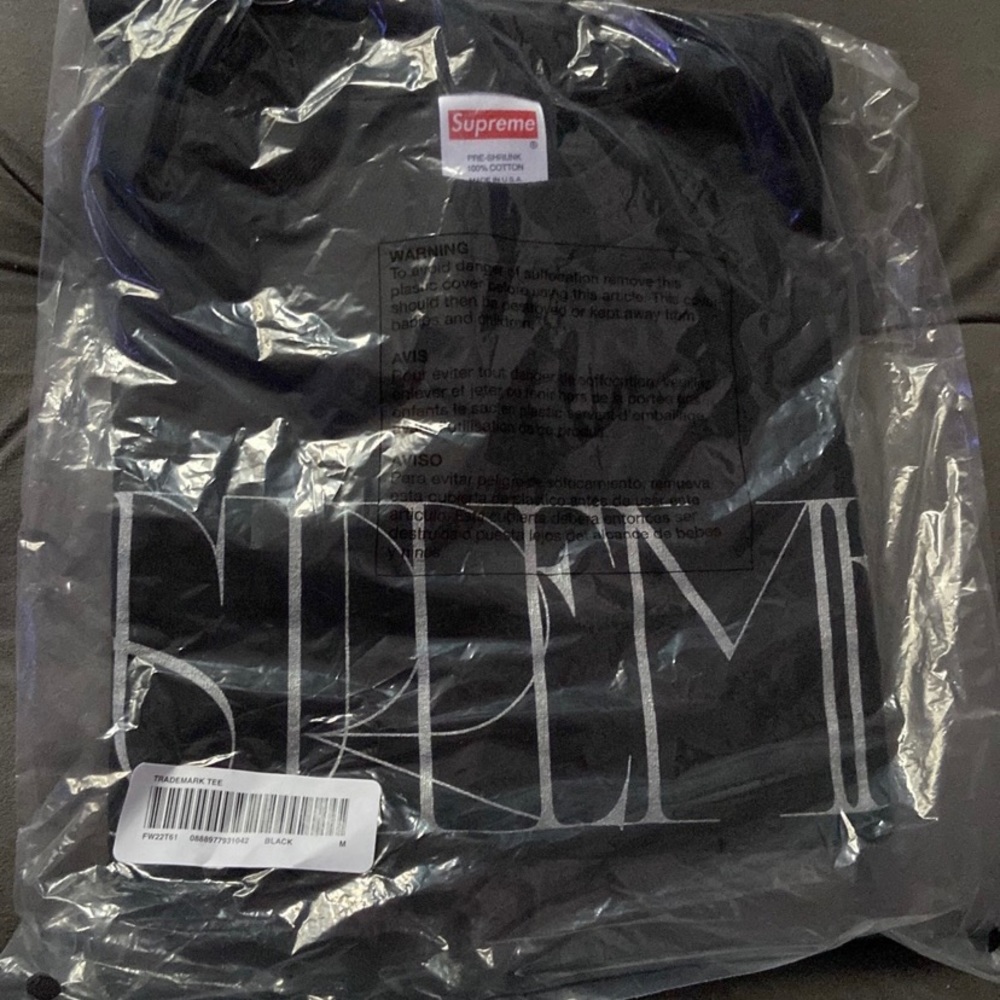 Supreme short sleeve black t shirt with supreme written across the front